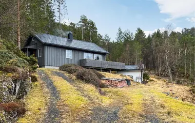 a house on a hill in the woods at 4 Bedroom Beautiful Home In Sekken in Molde