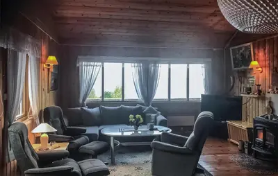 a living room with a couch and a table at 4 Bedroom Beautiful Home In Sekken in Molde