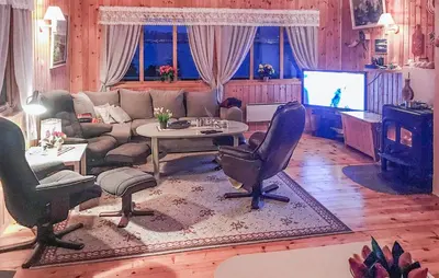 a living room with a couch and a tv at 4 Bedroom Beautiful Home In Sekken in Molde