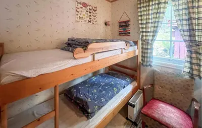 two bunk beds in a room with a window at 4 Bedroom Beautiful Home In Sekken in Molde