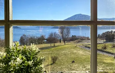 a window with a view of a field and a mountain at 2 Bedroom Cozy Home In Skodje in Skodje
