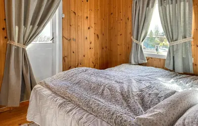 a bedroom with a bed and a window at 2 Bedroom Cozy Home In Skodje in Skodje