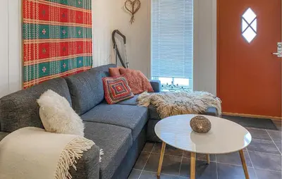 a living room with a blue couch and a table at Nice Apartment In Bjorli With Wifi in Bjorli