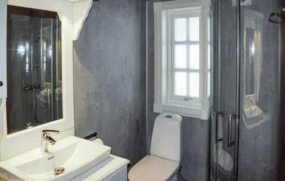 a bathroom with a sink and a toilet and a window at 4 Bedroom Nice Home In Engerdal in Kvisla