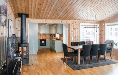a kitchen and dining room with a table and chairs at 4 Bedroom Nice Home In Engerdal in Kvisla
