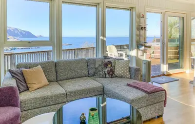 a living room with a couch and a view of the ocean at 2 Bedroom Lovely Home In Raudeberg in Raudeberg