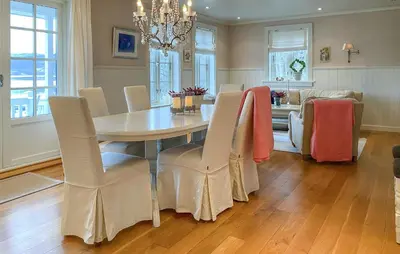 a dining room with a table and chairs and a couch at Amazing Home In Eiksund With Kitchen in Eiksund
