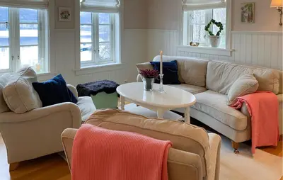 a living room with two couches and a table at Amazing Home In Eiksund With Kitchen in Eiksund