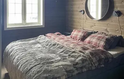 a bed with a blanket and pillows in a bedroom at Stunning Home In Eggedal With Wifi in Eggedal