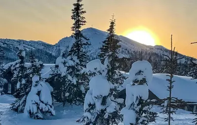 a group of trees covered in snow with the sunset in the background at Stunning Home In Eggedal With Wifi in Eggedal