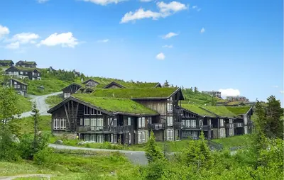 a house with a grass roof on a hill at Amazing Apartment In Noresund With Wifi in Noresund