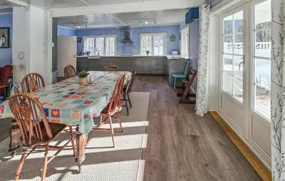 a kitchen and dining room with a table and chairs at Awesome Home In Noresund With Wifi in Noresund