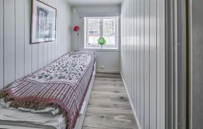 a bedroom with a bed with a blanket on it at Awesome Home In Noresund With Wifi in Noresund