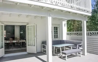 a porch with a bench and a table on a patio at Awesome Home In Noresund With Wifi in Noresund