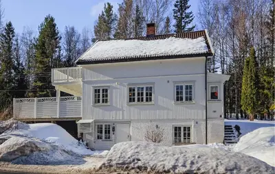 a white house with snow on top of it at Awesome Home In Noresund With Wifi in Noresund