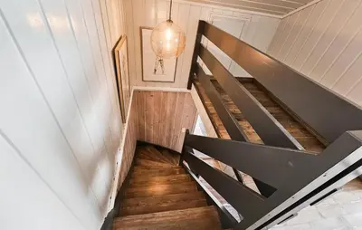 a staircase in a house with a black railing at Gorgeous Home In Rjukan With Kitchen in Rjukan