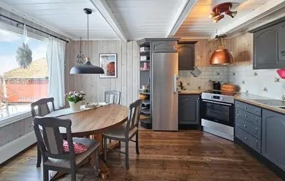 a kitchen with a wooden table and a dining room at Gorgeous Home In Rjukan With Kitchen in Rjukan