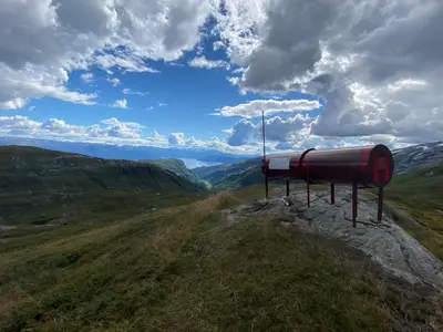 a pipe on the side of a hill with mountains at Kvamskogen & Hardanger Holliday homes in Norheimsund