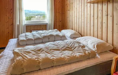 a large bed in a room with a window at Stunning Apartment In Eidsvåg I Romsdal in Toven