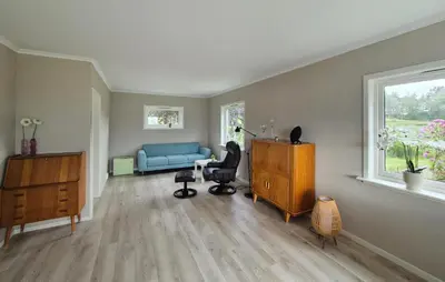 a living room with a blue couch and a chair at Amazing Home In Vikebygd With Wifi in Vikebygd
