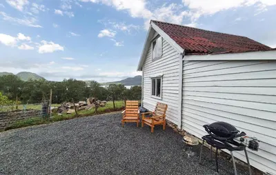 a white building with two chairs and a table at Amazing Home In Vikebygd With Wifi in Vikebygd