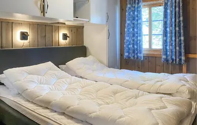 two large white beds in a room with a window at 4 Bedroom Gorgeous Home In Bjorli in Bjorli