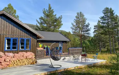 a house with a deck with chairs and a playground at 4 Bedroom Gorgeous Home In Bjorli in Bjorli