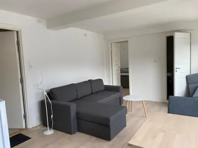 a living room with a couch and a table at Trolltun, Frystevegen 4 in Ulvik