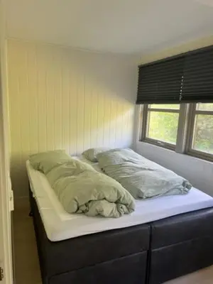 a bed with two pillows on it in a bedroom at Trolltun, Frystevegen 4 in Ulvik