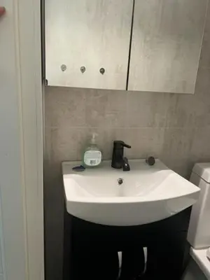 a white sink in a bathroom with a mirror at Trolltun, Frystevegen 4 in Ulvik