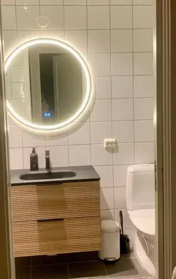 a bathroom with a sink and a mirror and a toilet at Stryn Golden Resort-«Skulehuset» in Stryn