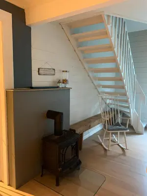 a stairway with a chair and a wooden floor at Stryn Golden Resort-«Skulehuset» in Stryn