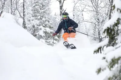 a man is skiing down a snow covered slope at Ski in/out Appartment Hemsedal in Hemsedal