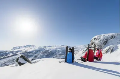 a group of people sitting on top of a snow covered mountain at Ski in/out Appartment Hemsedal in Hemsedal