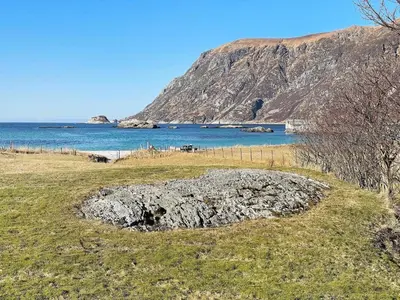 a view of a body of water with a mountain at 8 person holiday home in Bremanger in Grotle