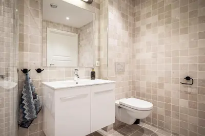 a bathroom with a white sink and a toilet at Gullstein in Geilo