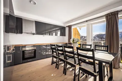 a kitchen and dining room with a table and chairs at Gullstein in Geilo