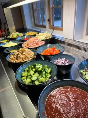 a bunch of bowls of food on a counter at Oppdalsporten Motell in Oppdal