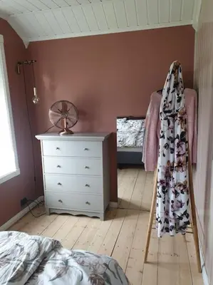 a bedroom with a white dresser and a bed and a dresser at Romslig og særegent hus in Skodje