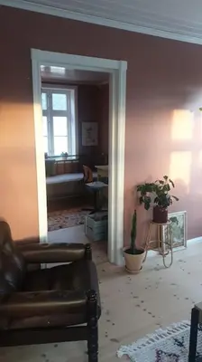 a living room with a couch and a window at Romslig og særegent hus in Skodje