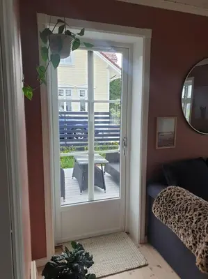 a room with a door leading to a patio at Romslig og særegent hus in Skodje