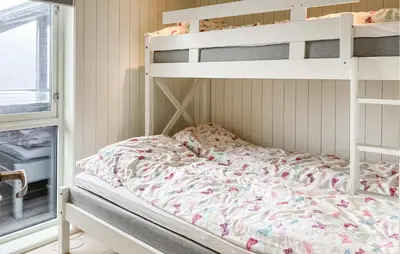 a white bunk bed in a room with a window at Lovely Home In Valldal in Valldal