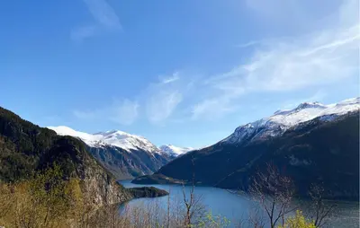 a view of a lake in the mountains with snow at Lovely Home In Valldal in Valldal