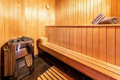a sauna with a bench and a trashcan in it at A wonderful estate of two houses for all seasons! in Trysil