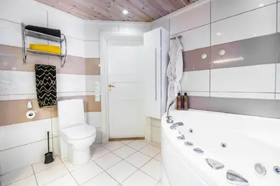a bathroom with a tub and a toilet and a sink at A wonderful estate of two houses for all seasons! in Trysil