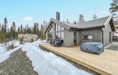a house on a wooden deck in the snow at Pet Friendly Home In Gålå With Kitchen in Gålå