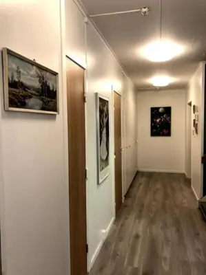 a hallway with paintings on the walls of a room at Jølster Lake View in Årdal