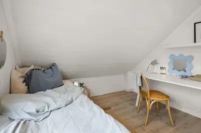 a bedroom with a bed and a desk with a chair at A beautiful 3-bedroom apartment with stunning views and free parking in Bergen