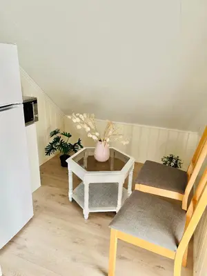 a small kitchen with a table and a white refrigerator at A beautiful 3-bedroom apartment with stunning views and free parking in Bergen