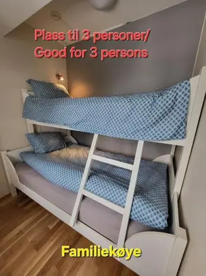 a room with two bunk beds with blue pillows at Ski in Ski out Trysil in the mountain of Norway 60m from the Slopes in Trysil